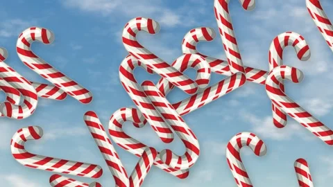 Red and White Striped Candy Canes Falling Against Blue Sky Stock Footage 344833047