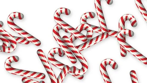 Red and White Striped Candy Canes Falling Against White Background Stock Footage 345206507