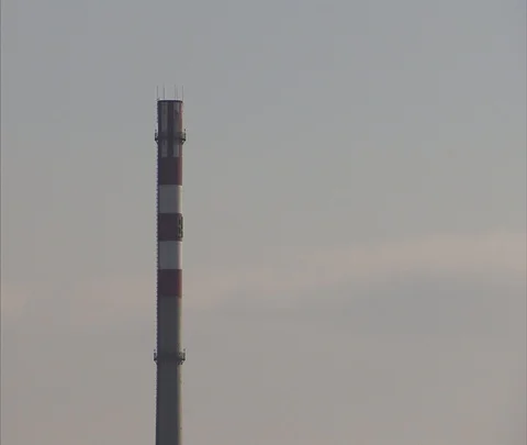Red and white striped chimney of coal burning power plant Stock Footage 86745053