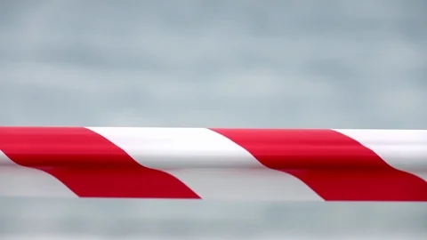 Red and white striped protective tape on wind in slow motion against white snow Video stock 125047287