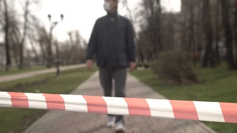 Red and white striped protective tape on the wind. Man takes tape in his hand Stock Footage 127773270