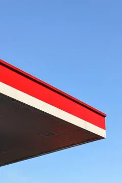 Red and white striped rooftops against a blue sky. Stock Photos