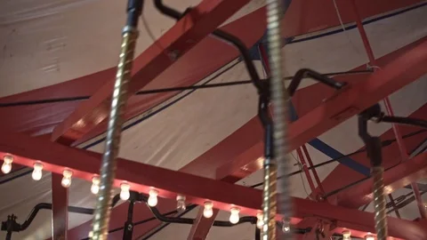 Red and white striped underside of carousel ride turning in slow motion Stock Footage 124668564