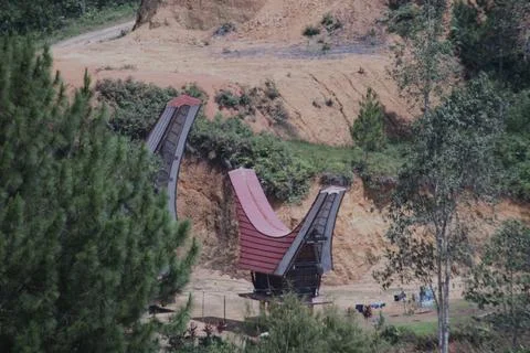 A red and white structure is on a hillside Stock Photos