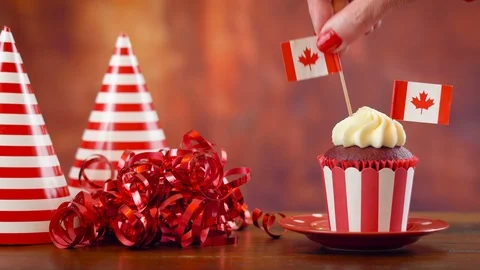 Red and white theme cupcake with Canadian maple leaf flags for first of July  Stock Footage 91160824