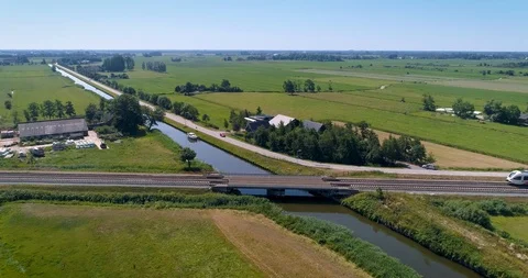 Red and White Train Crossing Bridge, Friesland, The Netherlands – 4K Drone Foota Stock Footage 120829573