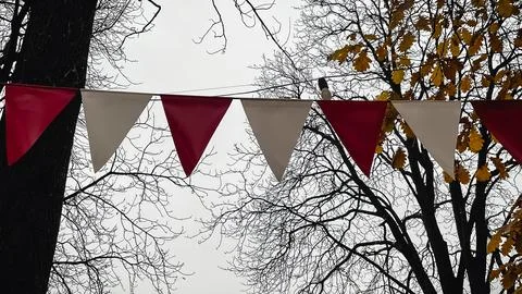 Red and white triangular bunting hanging against a background of bright yel.. 库存照片