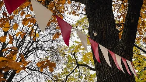 Red and white triangular bunting hanging against a background of bright yel.. Foto stock