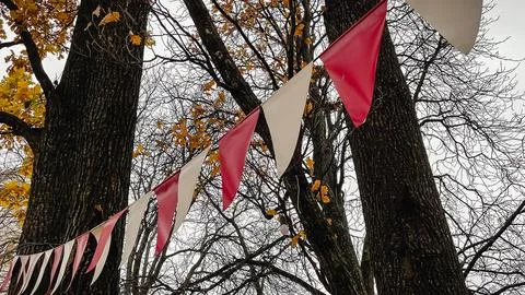 Red and white triangular bunting hanging against a background of bright yel.. 写真素材