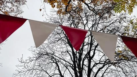 Red and white triangular bunting hanging against a background of bright yel.. Fotos de archivo