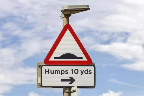 Red and White triangular Speed Humps Bumps Sleeping Policeman ahead warning sign Stock Photos