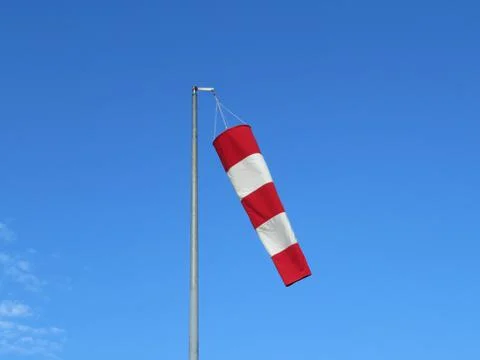 Red and white wind indicator safety signal warning Stock Photos