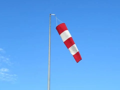 Red and white wind indicator safety signal warning Stock Photos