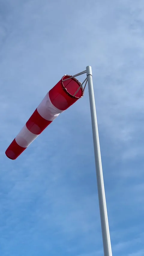 Red and White Windsock Blowing in Strong Wind Against Sky Stock Footage 341106440