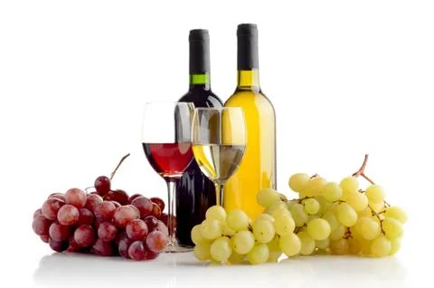 Red and white wine in bottles and wineglasses and two bunches of grape Stock Photos