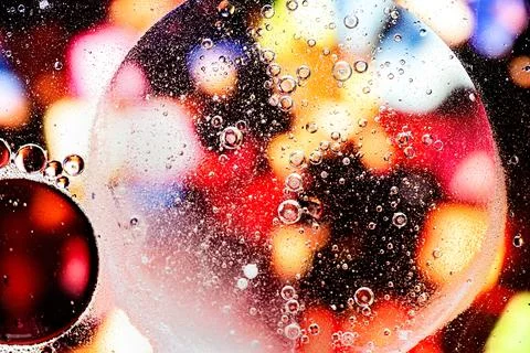 Red and yellow abstract pattern made with oil bubbles on water Stock Photos
