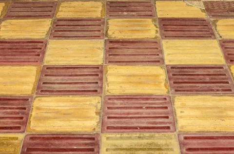 Red and yellow block pattern parking or pathway flooring tiles for background Stock Photos