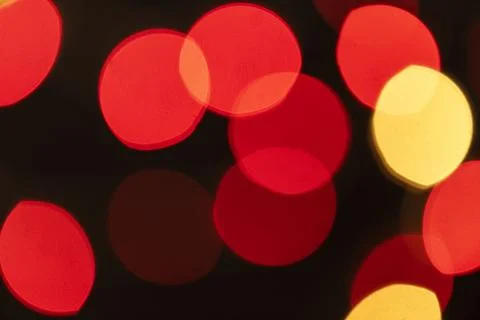Red and yellow bokeh pattern on a dark background wallpaper Stock Photos