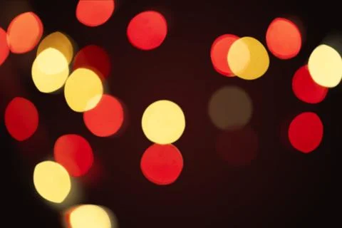 Red and yellow bokeh pattern on a dark background wallpaper Stock Photos
