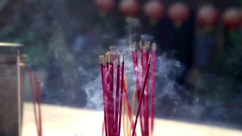 Red and yellow burning incense sticks with rising smoke Stock Footage 331990111