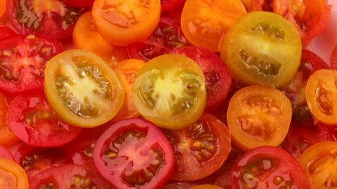 Red and yellow cherry tomato slices, rotation in circle. slice tomato, Turning. Stock Footage 276218694
