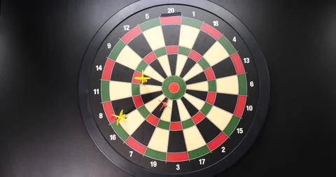Red and yellow darts going towards dart board isolated on black Stock Footage 205429952