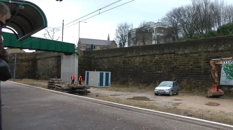 Red and yellow electric train arrives at station in city audio annoucement Stock Footage 1099488