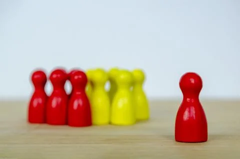 Red and Yellow figures positioned together and lead by the leader, represen.. Stock Photos