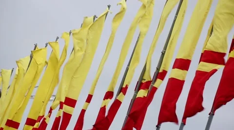 Red and yellow flags waving in a windy day. Stock Footage 57095849