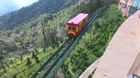 A red and yellow funicular train travels through Ba Na Hills, Vietnam. Stock Footage 333348734