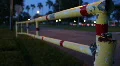 Red And Yellow Metal Gate With Traffic In Background HD Footage