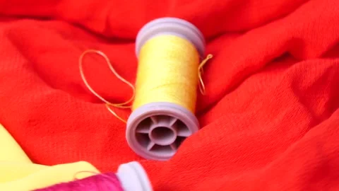 Red and yellow sewing spool rotating Video stock 248367854