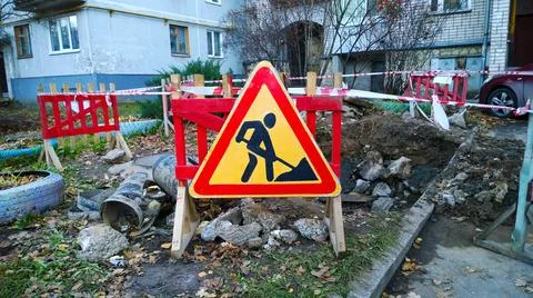 Red and yellow triangular Road warning sign denoting construction work Stock Photos