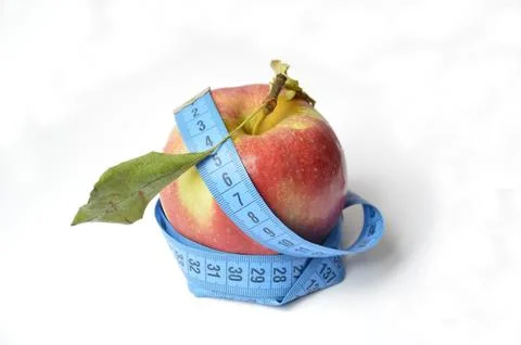 Red apple and soft centimeter on a white background. diet and proper nutrition Stock Photos