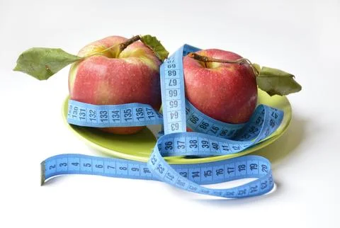 Red apple and soft centimeter on a white background. diet and proper nutrition Stock Photos