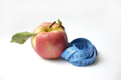 Red apple and soft centimeter on a white background. diet and proper nutrition Stock Photos