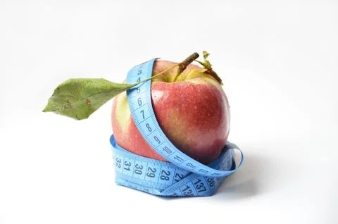 Red apple and soft centimeter on a white background. diet and proper nutrition Stock Photos
