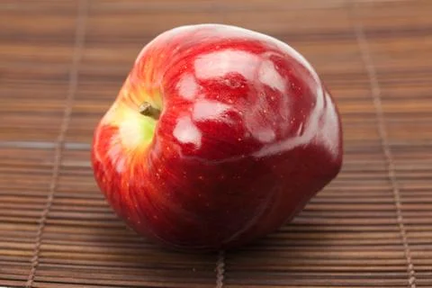 Red apple on a bamboo mat Stock Photos