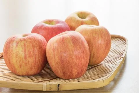 Red apple in basket Stock Photos