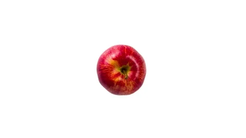 Red apple being cut on white background. Stop motion Stock Footage 132481781