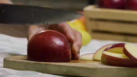 Red apple being sliced up on cutting board - closeup, slow motion Stock Footage 341272551