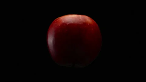 Red apple on a black background in a turning motion Stock Footage 172689353