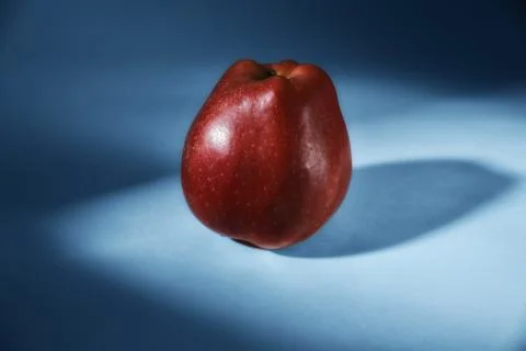 Red apple on blue background Stock Photos