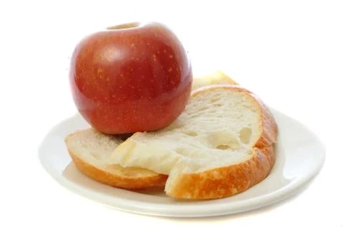 Red apple with bread on plate isolated on white background. Stock Photos