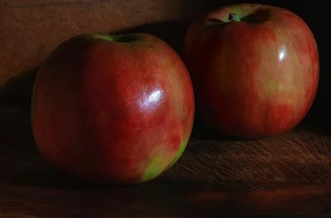 Red apple close-up low key on wooden surface Stock Photos