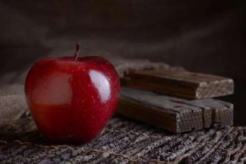 Red apple on deoevensky table. Stock Photos