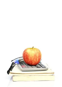 Red apple fruits on book stack and calculator with glasses Stock Photos