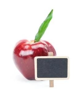 Red apple with green leaf and a board isolated on white Foto stock