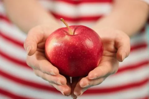 Red apple in hand close up Stock Photos