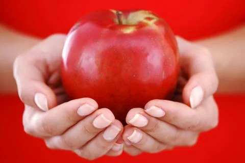 Red apple in hand Stock Photos